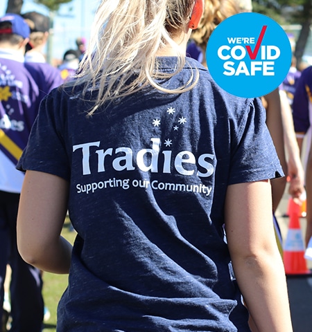 Tradies Volunteer with the venue COVID safe badge